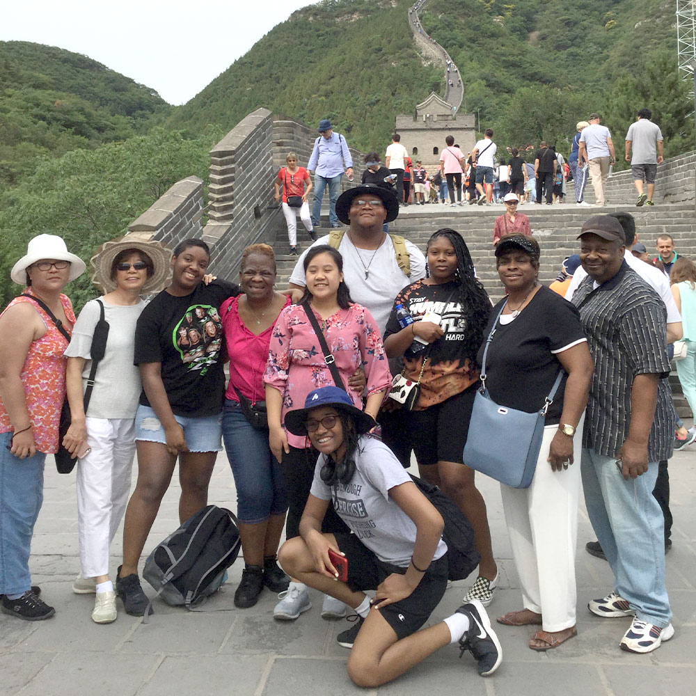 group of travelers taking a break for a photograph while climbing up a long mountain pass
